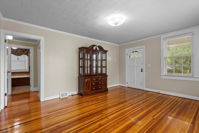 entrance foyer with tile floors and crown molding