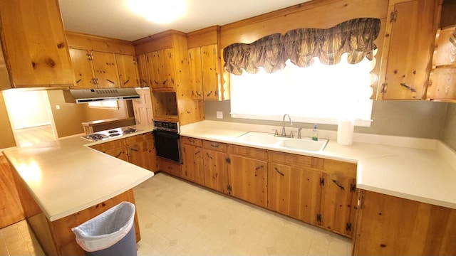 kitchen with white gas cooktop, oven, light tile floors, and sink