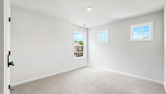 carpeted spare room with plenty of natural light