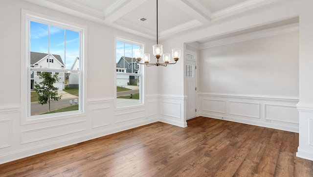 unfurnished dining area featuring crown molding, dark hardwood / wood-style floors, beamed ceiling, and a notable chandelier