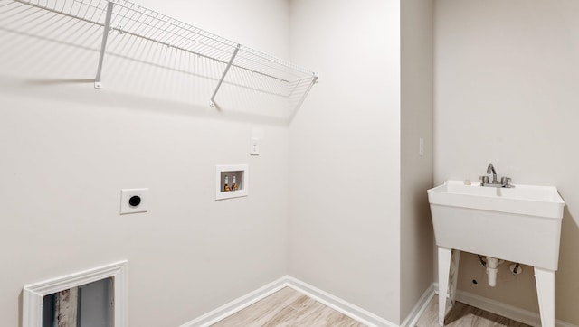 washroom with hookup for a washing machine, electric dryer hookup, and hardwood / wood-style flooring