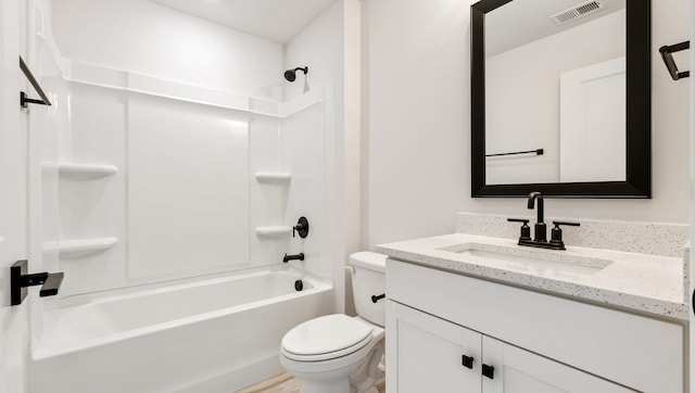 full bathroom featuring vanity, bathing tub / shower combination, and toilet