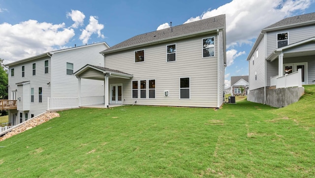 back of property featuring a patio, central air condition unit, and a yard