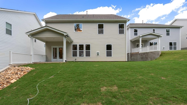 rear view of house featuring a lawn and a patio area