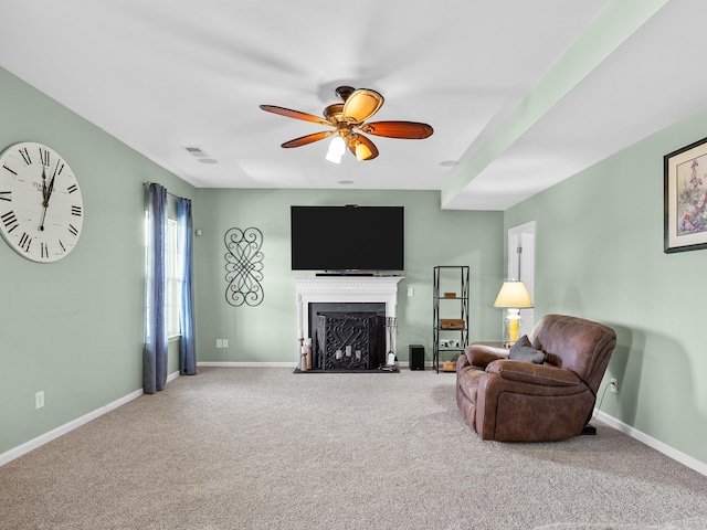 living room featuring carpet floors and ceiling fan