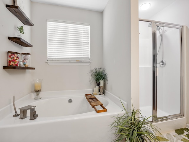 bathroom featuring shower with separate bathtub