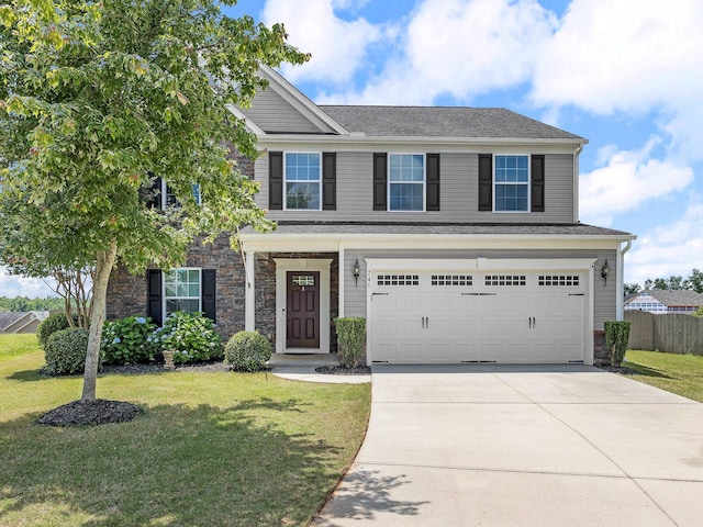 view of front of home with a front yard and a garage