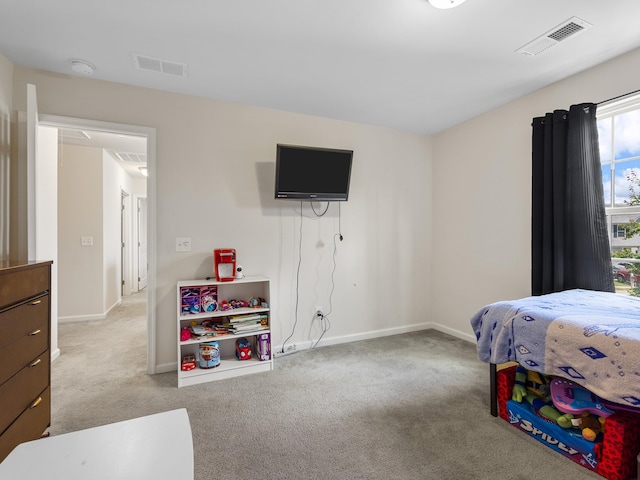 bedroom featuring light colored carpet