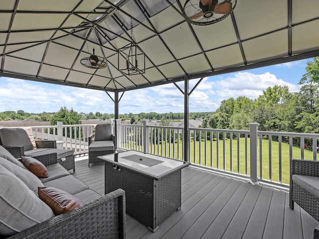 wooden terrace with a lawn and an outdoor living space