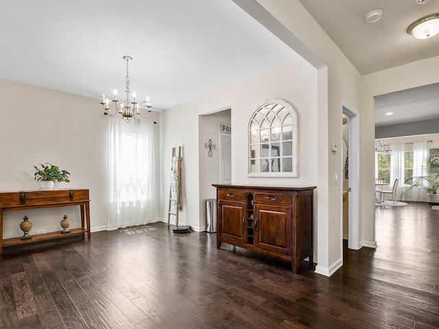 interior space with dark hardwood / wood-style flooring and a chandelier