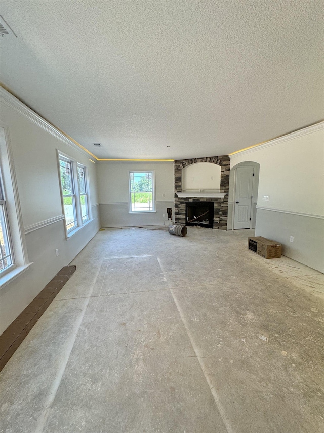 unfurnished living room featuring a fireplace and a textured ceiling