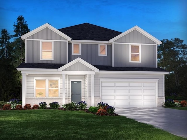 view of front of home with a garage and a front lawn