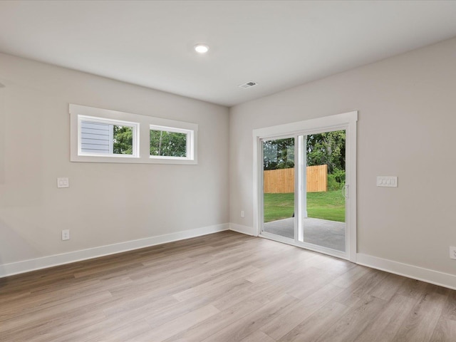 empty room featuring a healthy amount of sunlight and light wood-type flooring