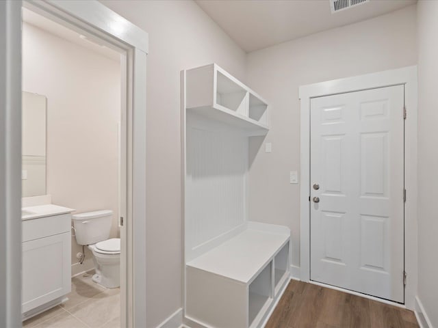 mudroom with light hardwood / wood-style floors