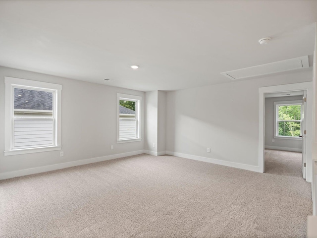 spare room featuring light colored carpet