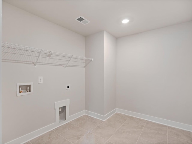 laundry room with washer hookup, electric dryer hookup, and light tile patterned flooring