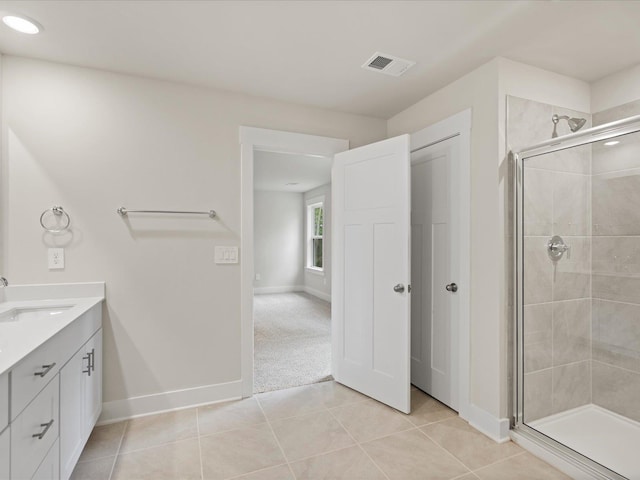 bathroom with tile patterned flooring, vanity, and an enclosed shower