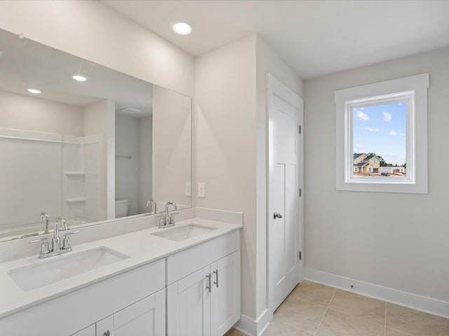 bathroom with tile patterned flooring, vanity, and toilet