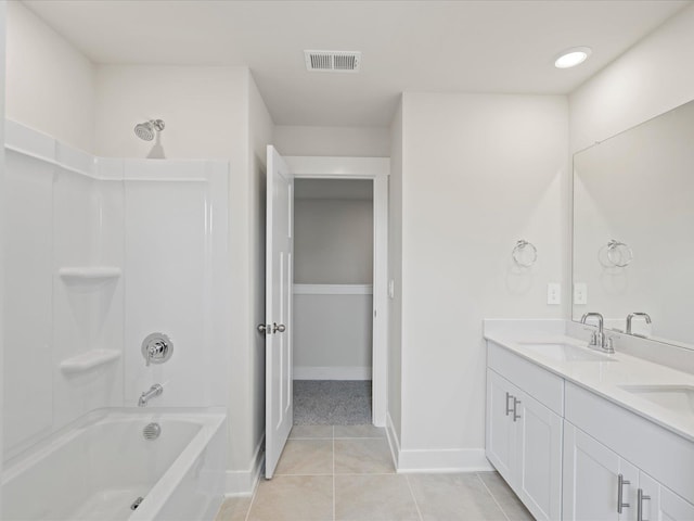 bathroom with tile patterned flooring, vanity, and shower / tub combination