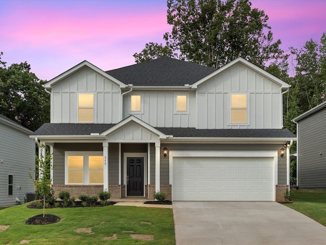 craftsman-style home with a yard, a garage, and central AC unit