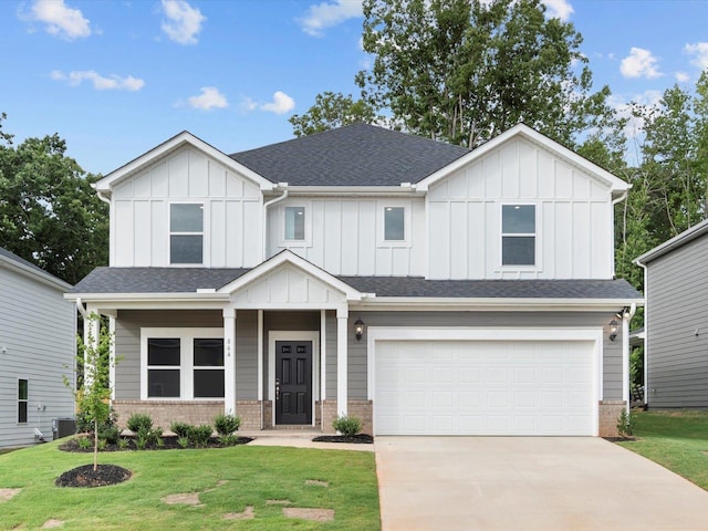 view of front of property featuring central AC unit, a garage, and a front yard