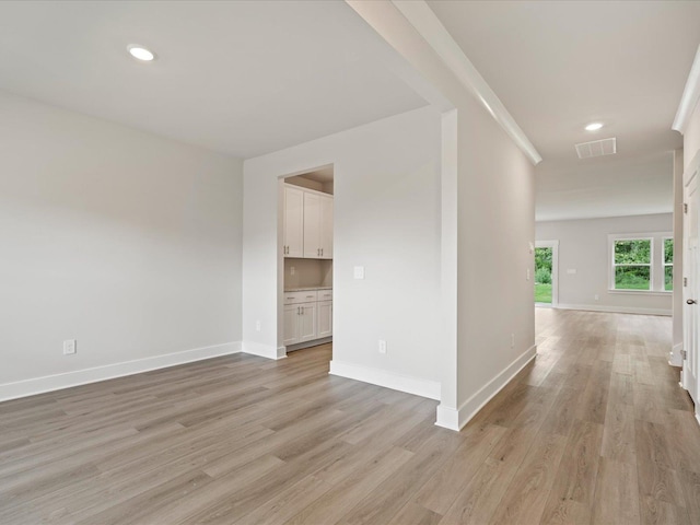 spare room featuring light hardwood / wood-style floors