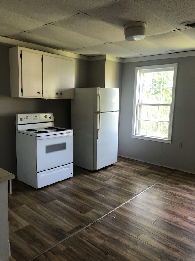 kitchen featuring white cabinetry, white appliances, dark hardwood / wood-style flooring, and a drop ceiling