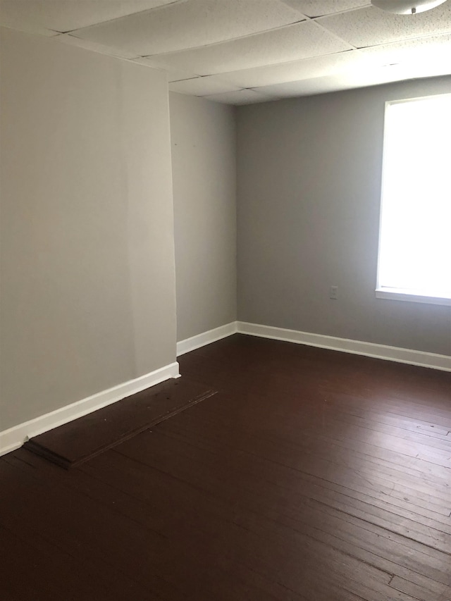 empty room with dark hardwood / wood-style flooring