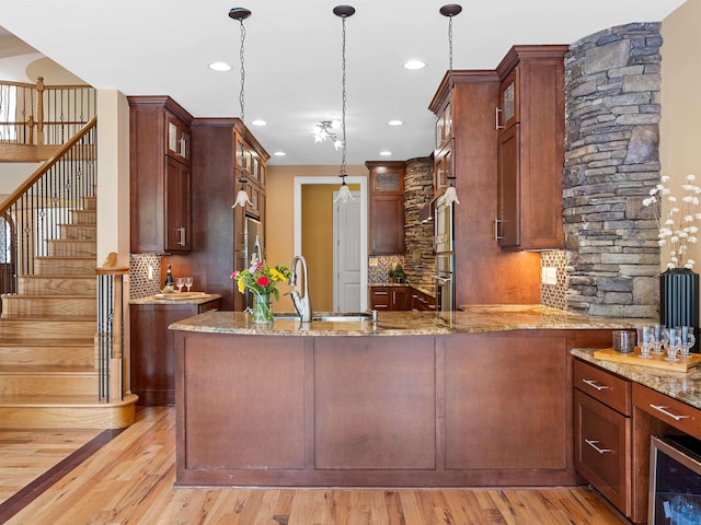 kitchen with pendant lighting, sink, and beverage cooler