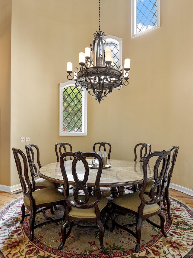 dining room with hardwood / wood-style floors and a notable chandelier