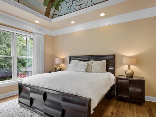 bedroom with wood-type flooring and crown molding