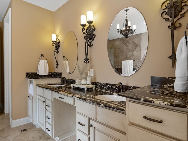 bathroom featuring tile patterned floors, a notable chandelier, and vanity