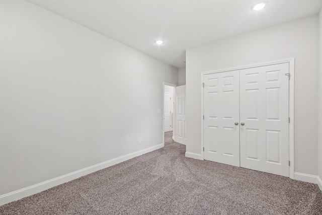 unfurnished bedroom with carpet and a closet