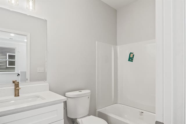 full bathroom with  shower combination, vanity, and toilet