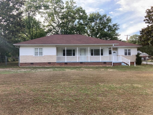 ranch-style home with a porch and a front yard