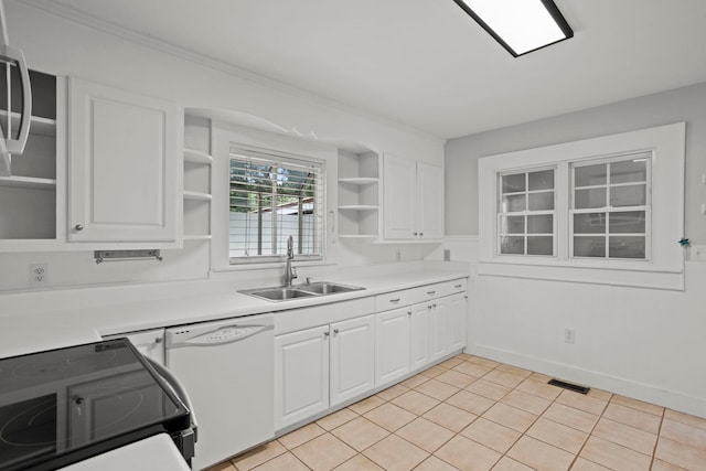 kitchen featuring white cabinetry, dishwasher, sink, stove, and light tile patterned floors