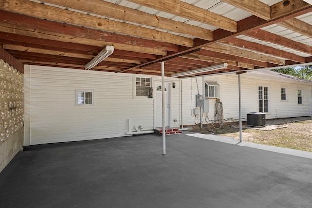 view of patio with central AC and a carport