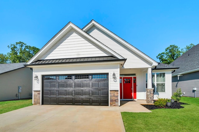 craftsman house with a garage and a front lawn