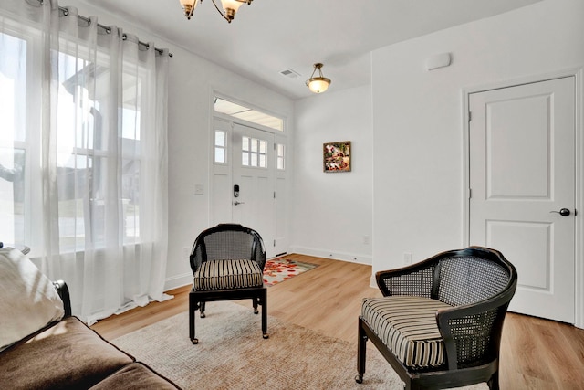 sitting room with a wealth of natural light and light hardwood / wood-style flooring