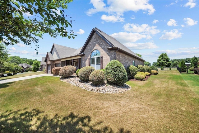 view of home's exterior with a lawn and a garage