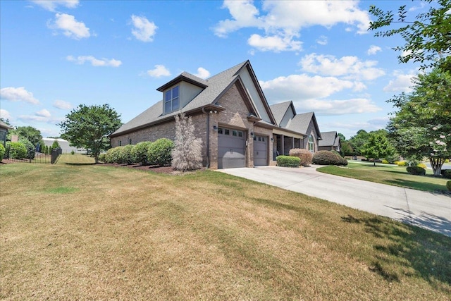 view of front of house featuring a garage and a front lawn