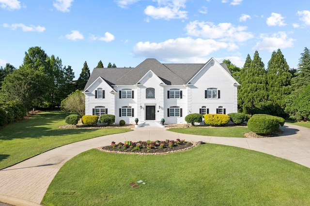 view of front of home with a front yard and driveway