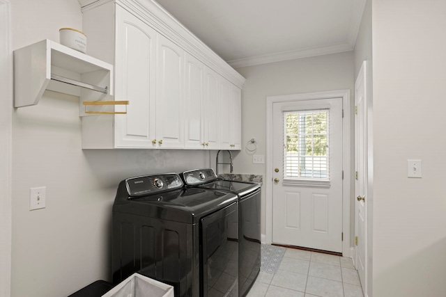 laundry room featuring crown molding, light tile patterned flooring, cabinet space, and washer and dryer