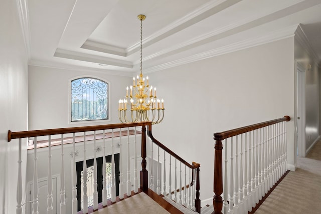 stairs with carpet floors, baseboards, a tray ceiling, an inviting chandelier, and crown molding