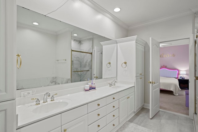 full bathroom with double vanity, a marble finish shower, ornamental molding, and a sink