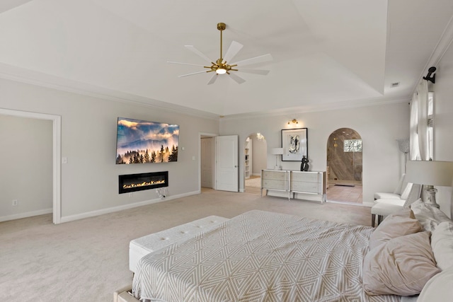 bedroom featuring arched walkways, light colored carpet, baseboards, a raised ceiling, and crown molding