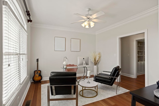 living area with a healthy amount of sunlight, visible vents, and wood finished floors