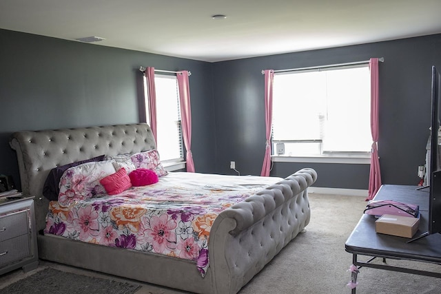 bedroom featuring light carpet