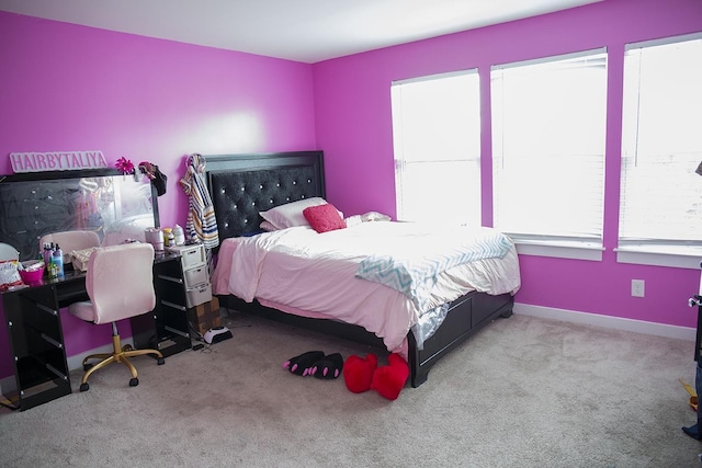 carpeted bedroom featuring multiple windows