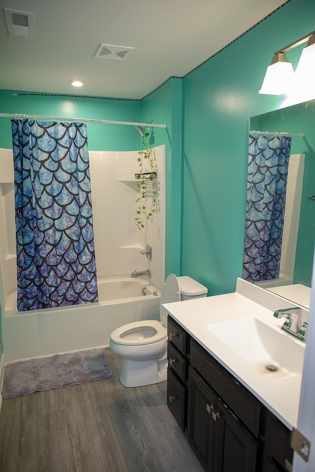 full bathroom with hardwood / wood-style floors, shower / bath combo, toilet, and vanity